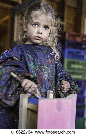 Girl painting wooden house View Large Photo Image Picture - Girl painting wooden house. Fotosearch