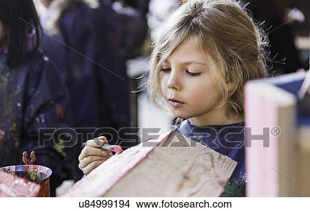 Girl painting wooden house View Large Photo Image Picture - Girl painting wooden house. Fotosearch