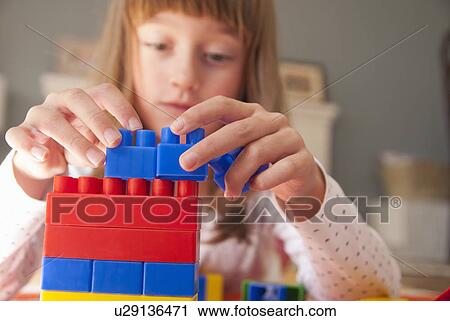 Girl playing with building blocks View Large Photo Image Stock Image - Girl playing with building blocks. Fotosearch