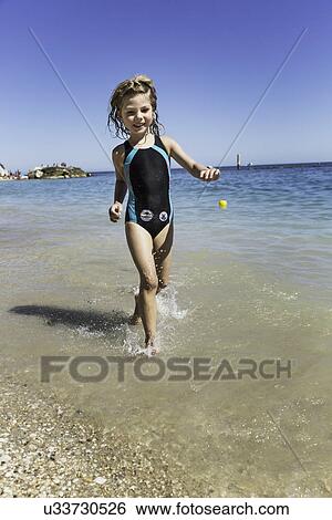 Girl running in sea View Large Photo Image Stock Photograph - Girl running in sea. Fotosearch