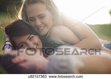 Girls chatting on grass View Large Photo Image Stock Image - Girls chatting on grass. Fotosearch