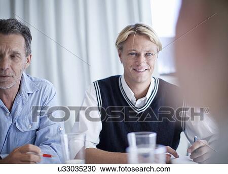 Group of business people holding a meeting View Large Photo Image Stock Image - Group of business people holding a meeting. Fotosearch