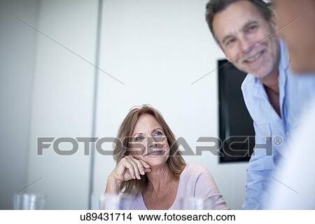 Picture - Group of businessmen and women having a meeting. Fotosearch