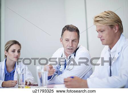 Stock Photography - Group of doctors holding a meeting in conference room. Fotosearch