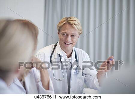Stock Image - Group of doctors meeting in conference room. Fotosearch