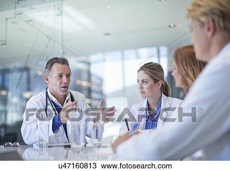 Stock Image - Group of doctors meeting in the conference room. Fotosearch