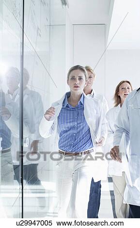 Group of doctors running along corridor to emergency View Large Photo Image Stock Photography - Group of doctors running along corridor to emergency. Fotosearch