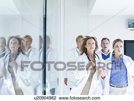 Group of doctors running to respond to emergency View Large Photo Image Stock Image - Group of doctors running to respond to emergency. Fotosearch