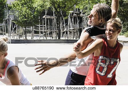 Group of friends enjoying basketball in park View Large Photo Image Stock Image - Group of friends enjoying basketball in park. Fotosearch