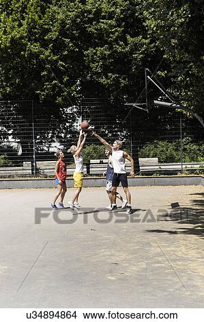 Group of friends playing basketball on court in park View Large Photo Image Picture - Group of friends playing basketball on court in park. Fotosearch