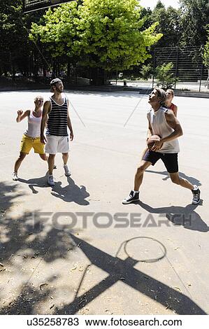 Group of friends playing basketball View Large Photo Image Stock Image - Group of friends playing basketball. Fotosearch
