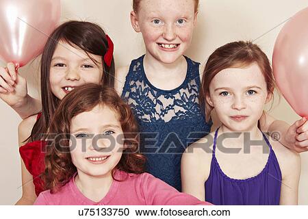Stock Image - Group of girls at a birthday party. Fotosearch