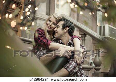 Happy couple sitting on traditional city apartment steps View Large Photo Image Picture - Happy couple sitting on traditional city apartment steps. Fotosearch
