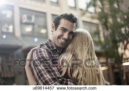 Happy young couple hugging on street, New York City, USA View Large Photo Image Stock Photo - Happy young couple hugging on street, New York City, USA. Fotosearch