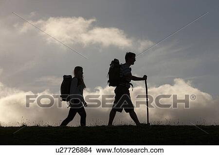 Picture - Hikers with backpack and walking stick. Fotosearch