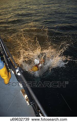 Lifeboat crew training with team member in sea View Large Photo Image Stock Photo - Lifeboat crew training with team member in sea. Fotosearch