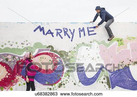 Stock Image - Man proposing to pregnant woman. Fotosearch