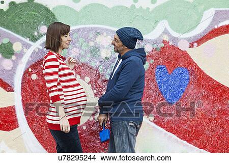 Man talking to pregnant woman View Large Photo Image Picture - Man talking to pregnant woman. Fotosearch