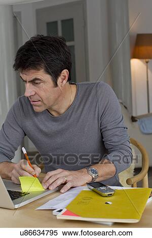 Mature businessman working at home View Large Photo Image Stock Photography - Mature businessman working at home. Fotosearch