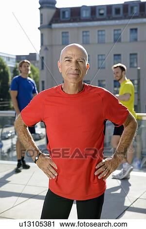 Mature male trainer and class taking a break on city rooftop View Large Photo Image Stock Image - Mature male trainer and class taking a break on city rooftop. Fotosearch