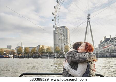 Mature tourist couple hugging near London Eye, London, UK View Large Photo Image Stock Photo - Mature tourist couple hugging near London Eye, London, UK. Fotosearch