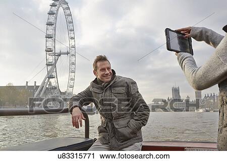 Mature tourist couple photographing selves and London Eye, London, UK View Large Photo Image Stock Image - Mature tourist couple photographing selves and London Eye, London, UK. Fotosearch