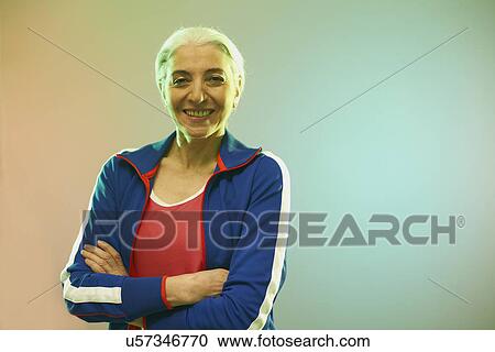 Stock Image - Mature woman wearing tracksuit top. Fotosearch