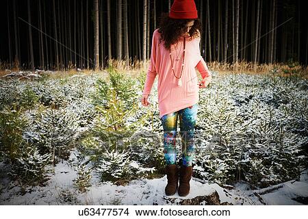 Mid adult woman in hat, standing on snow covered ground View Large Photo Image Picture - Mid adult woman in hat, standing on snow covered ground. Fotosearch