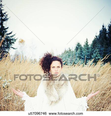 Mid adult woman practicing yoga in forest View Large Photo Image Stock Photograph - Mid adult woman practicing yoga in forest. Fotosearch