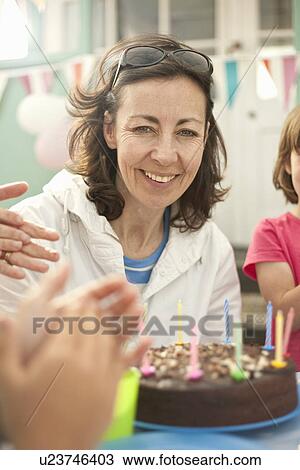Mother and children enjoying birthday outdoors View Large Photo Image Stock Image - Mother and children enjoying birthday outdoors. Fotosearch