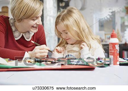 Mother and daughter drawing at kitchen table View Large Photo Image Stock Photography - Mother and daughter drawing at kitchen table. Fotosearch
