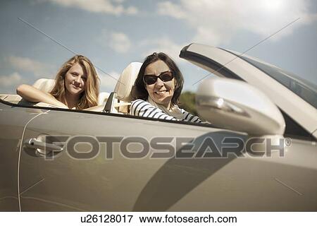 Mother and daughter in sports convertible View Large Photo Image Stock Photo - Mother and daughter in sports convertible. Fotosearch