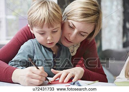 Mother and son drawing at kitchen table View Large Photo Image Stock Image - Mother and son drawing at kitchen table. Fotosearch