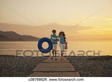 Mother and teenage son on boardwalk, Fethiye, Turkey View Large Photo Image Stock Photograph - Mother and teenage son on boardwalk, Fethiye, Turkey. Fotosearch
