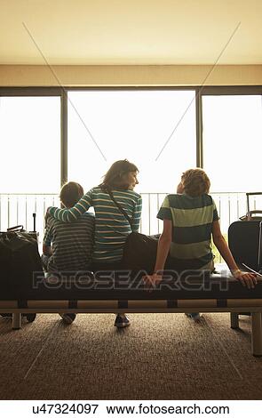 Mother and two sons in departure lounge at airport View Large Photo Image Stock Photo - Mother and two sons in departure lounge at airport. Fotosearch