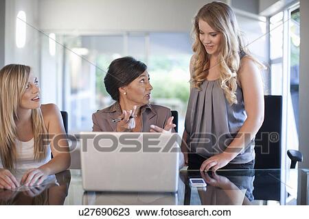 Stock Image - Office manager meeting with two trainees. Fotosearch