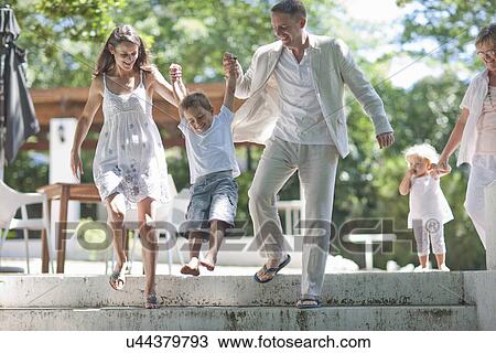 Parents lifting son over steps View Large Photo Image Stock Image - Parents lifting son over steps. Fotosearch