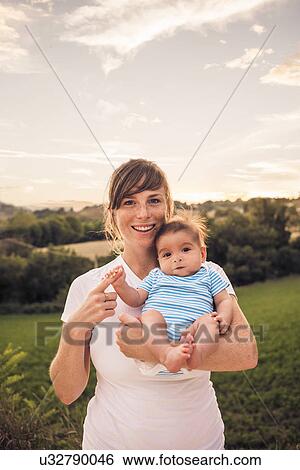 Portrait of baby girl gripping mothers finger View Large Photo Image Stock Photograph - Portrait of baby girl gripping mothers finger. Fotosearch