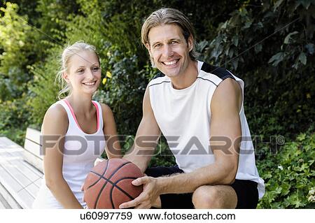 Portrait of basketball players taking a break in park View Large Photo Image Stock Photo - Portrait of basketball players taking a break in park. Fotosearch