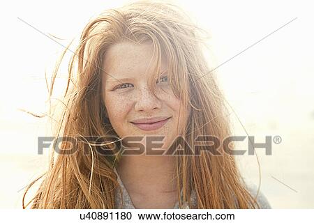 Stock Image - Portrait of beautiful girl smiling. Fotosearch