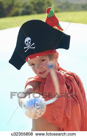 Stock Photo - Portrait of boy in pirates hat, pointing toy sword. Fotosearch