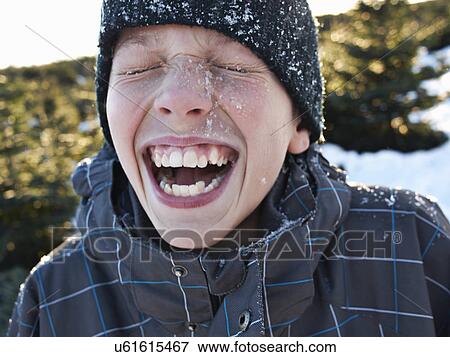 Stock Photo - Portrait of boy laughing with eyes closed. Fotosearch