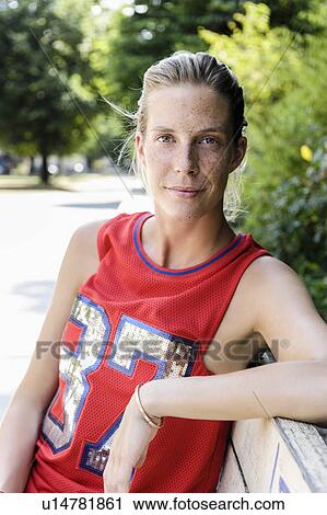 Portrait of female basketball player taking a break in park View Large Photo Image Stock Image - Portrait of female basketball player taking a break in park. Fotosearch