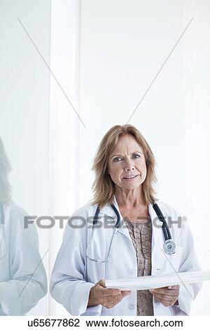 Portrait of female doctor holding medical notes View Large Photo Image Stock Image - Portrait of female doctor holding medical notes. Fotosearch
