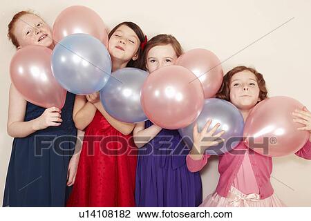 Portrait of four girls holding balloons View Large Photo Image Stock Image - Portrait of four girls holding balloons. Fotosearch