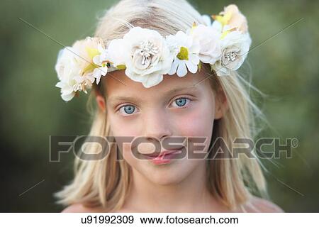 Stock Photo - Portrait of girl with flower garland in her hair. Fotosearch