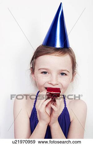Portrait of girl with party blower wearing party hat View Large Photo Image Stock Photo - Portrait of girl with party blower wearing party hat. Fotosearch