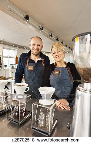 Portrait of mature couple in coffee shop kitchen View Large Photo Image Stock Photo - Portrait of mature couple in coffee shop kitchen. Fotosearch