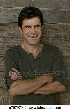Portrait of mature man leaning against garden shed View Large Photo Image Stock Image - Portrait of mature man leaning against garden shed. Fotosearch
