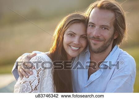 Stock Image - Portrait of mid adult couple outdoors. Fotosearch